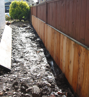 Mud and stone ... a goog reason for raised garden beds.