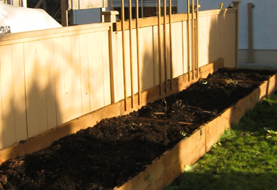 A raised bed garden that is a little too wide to work from one side